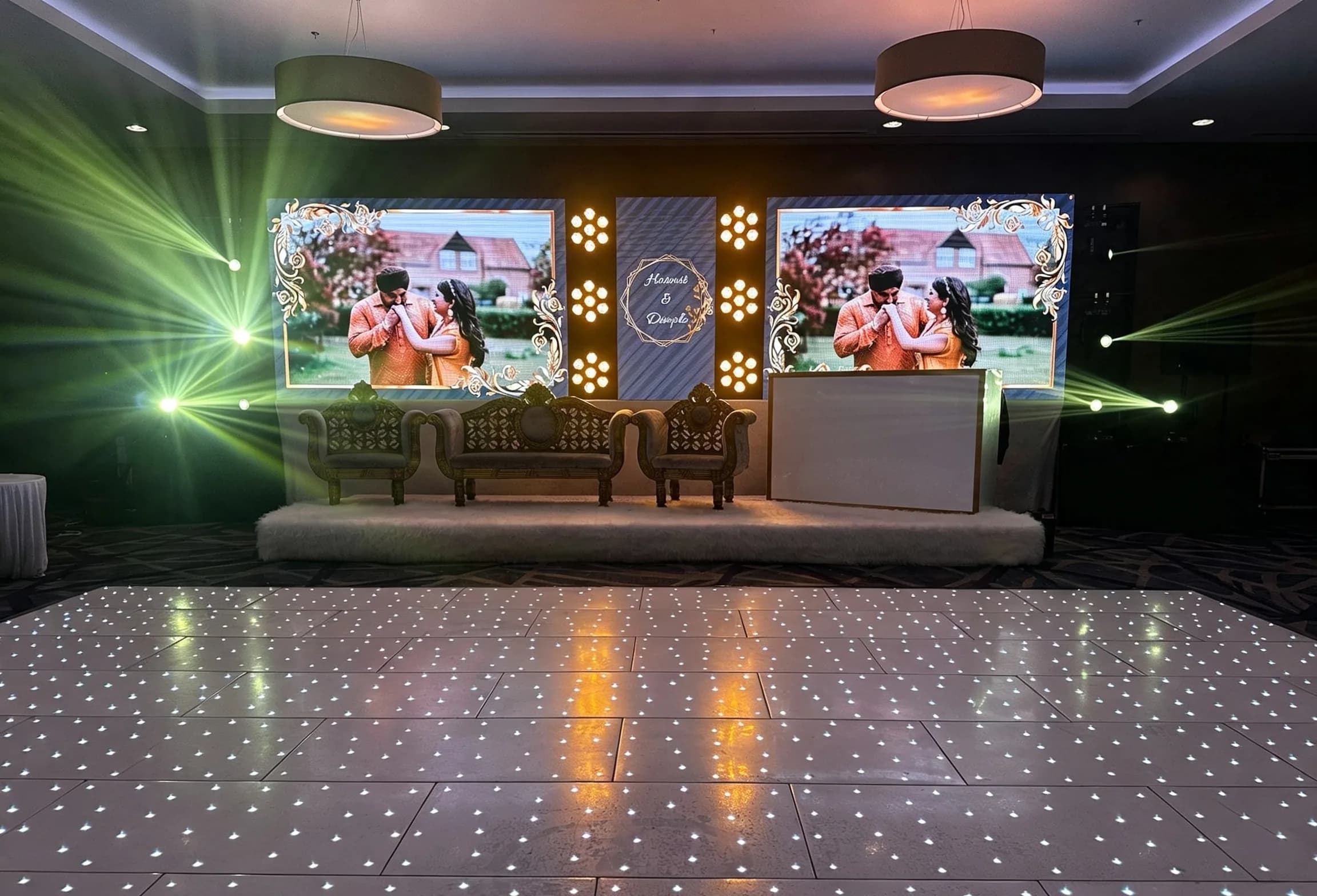 Asian wedding stage and dance floor prepared for an evening celebration
